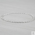 Silver marina link bracelet on a light gray background