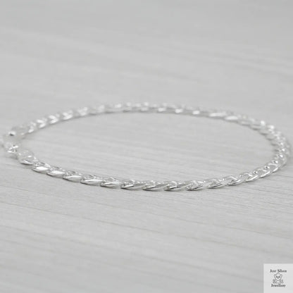 Silver marina link bracelet on a light gray background