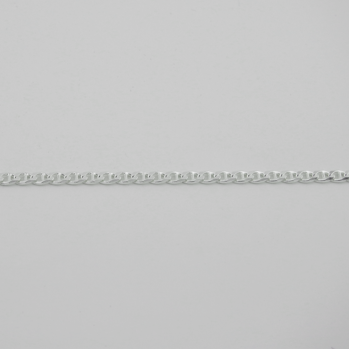 Silver chain bracelet on a light gray background