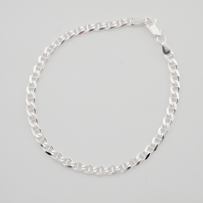 Silver chain necklace on a light gray background