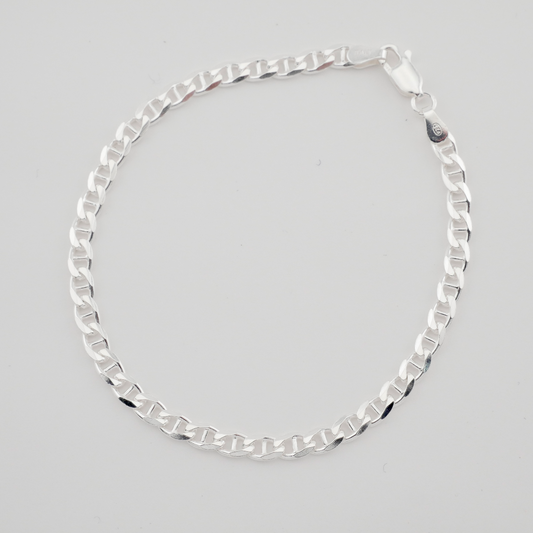 Silver chain necklace on a light gray background