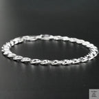 Silver chain bracelet on a black background