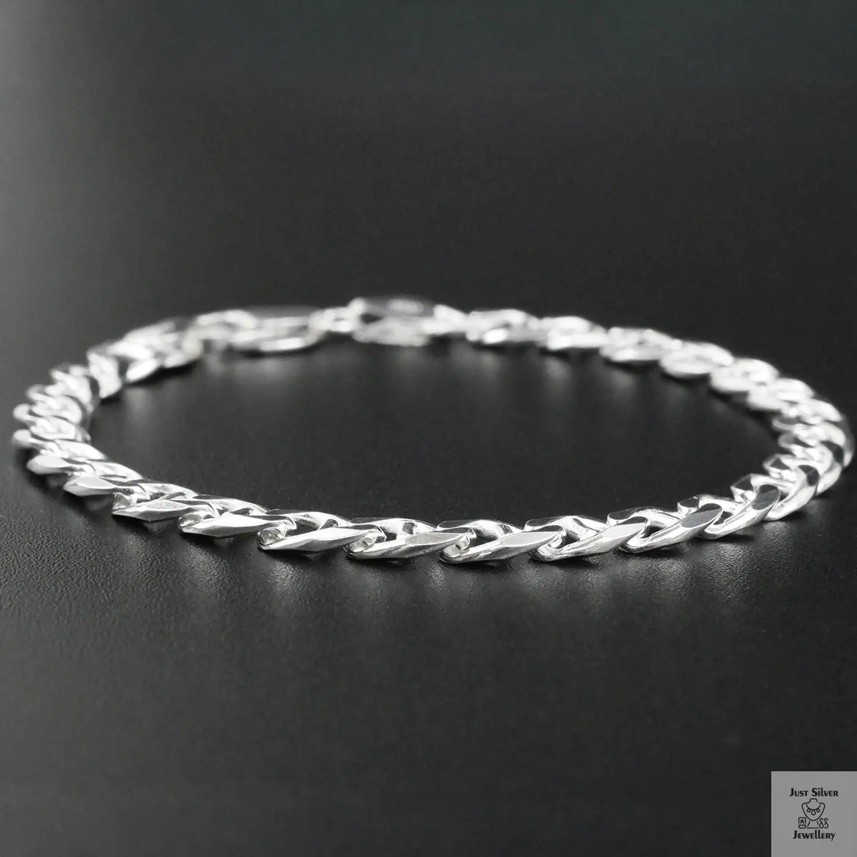 Silver chain bracelet on a black background