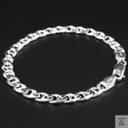 Silver chain bracelet on a black background
