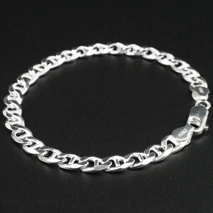 Silver chain bracelet on a black background