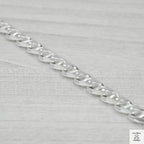 Silver chain on a light grey background