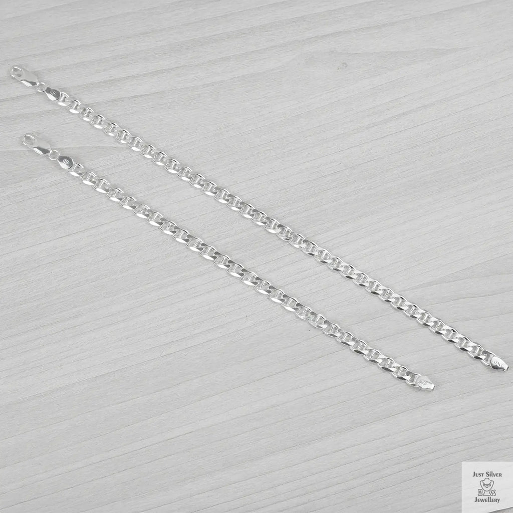 Silver bracelets on a textured grey surface
