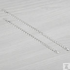 Silver bracelets on a textured grey surface