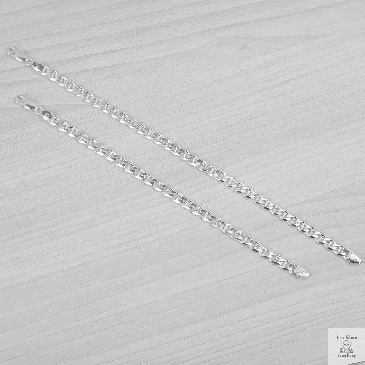 Silver bracelets on a textured grey surface