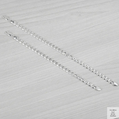 Silver bracelets on a textured grey surface
