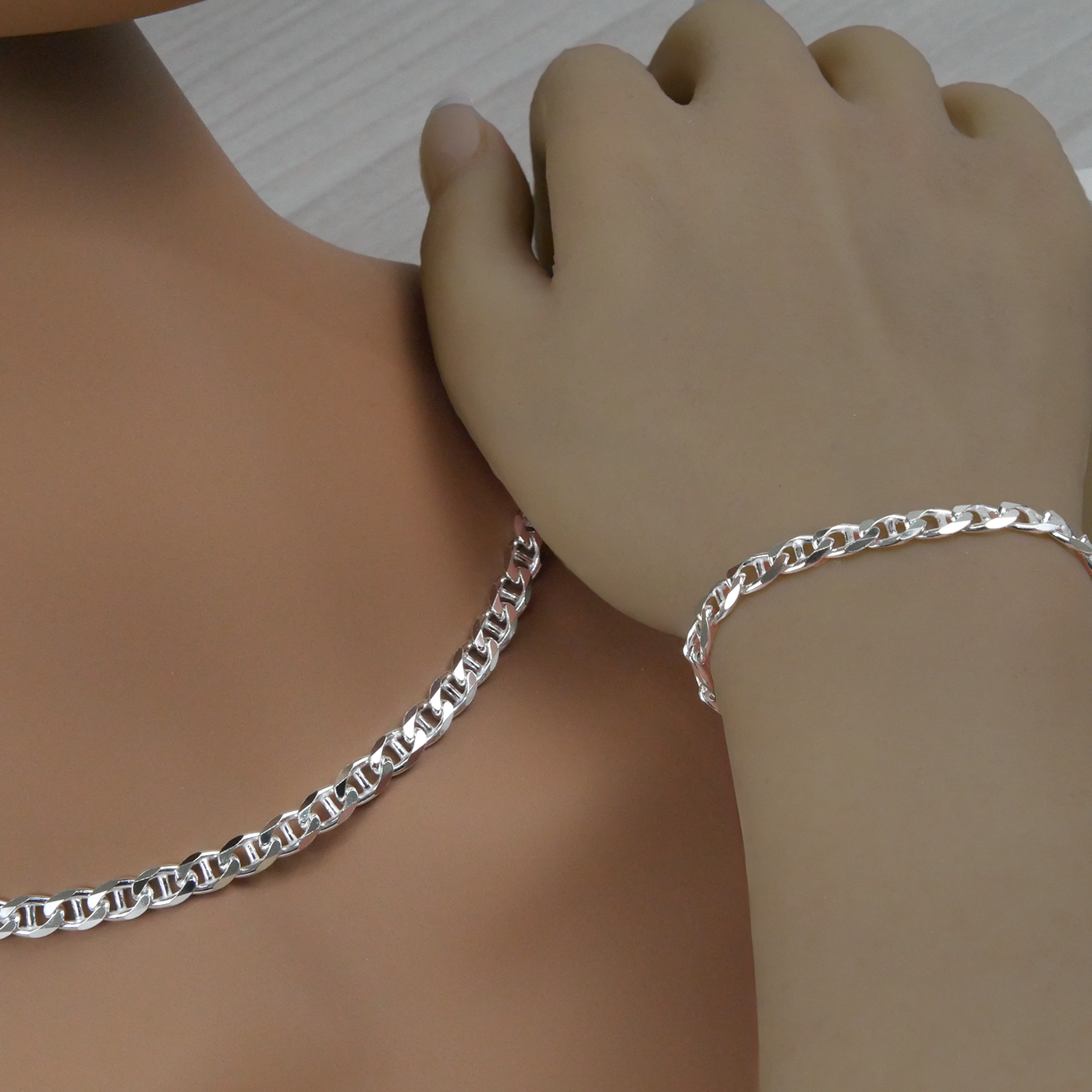 Silver marina chain necklace and bracelet on a mannequin and hand