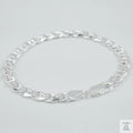 Silver chain bracelet on a light grey background