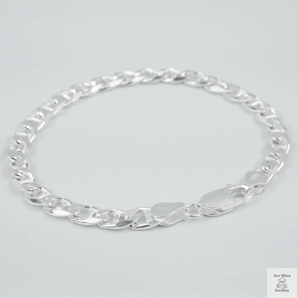 Silver chain bracelet on a light grey background