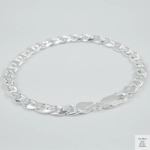 Silver chain bracelet on a light grey background