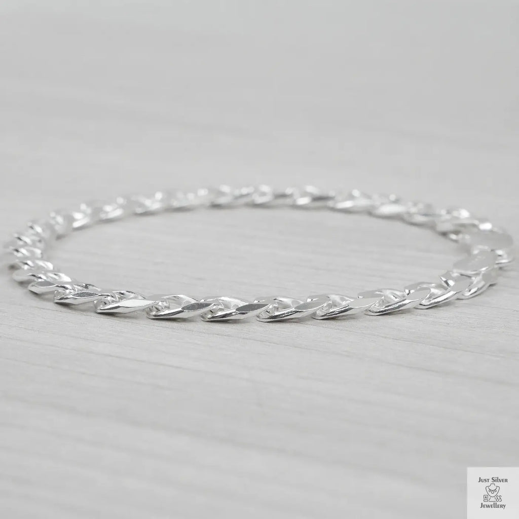 Silver bracelet on a light grey background