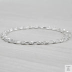Silver bracelet on a light grey background