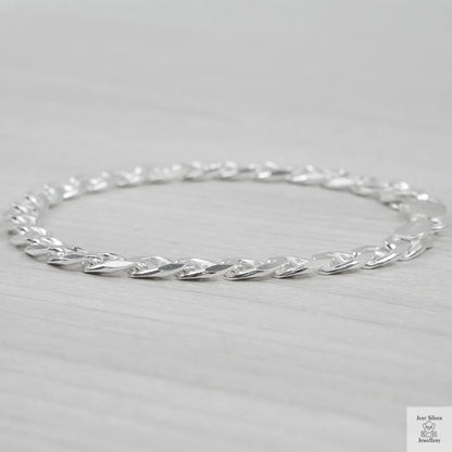 Silver bracelet on a light grey background