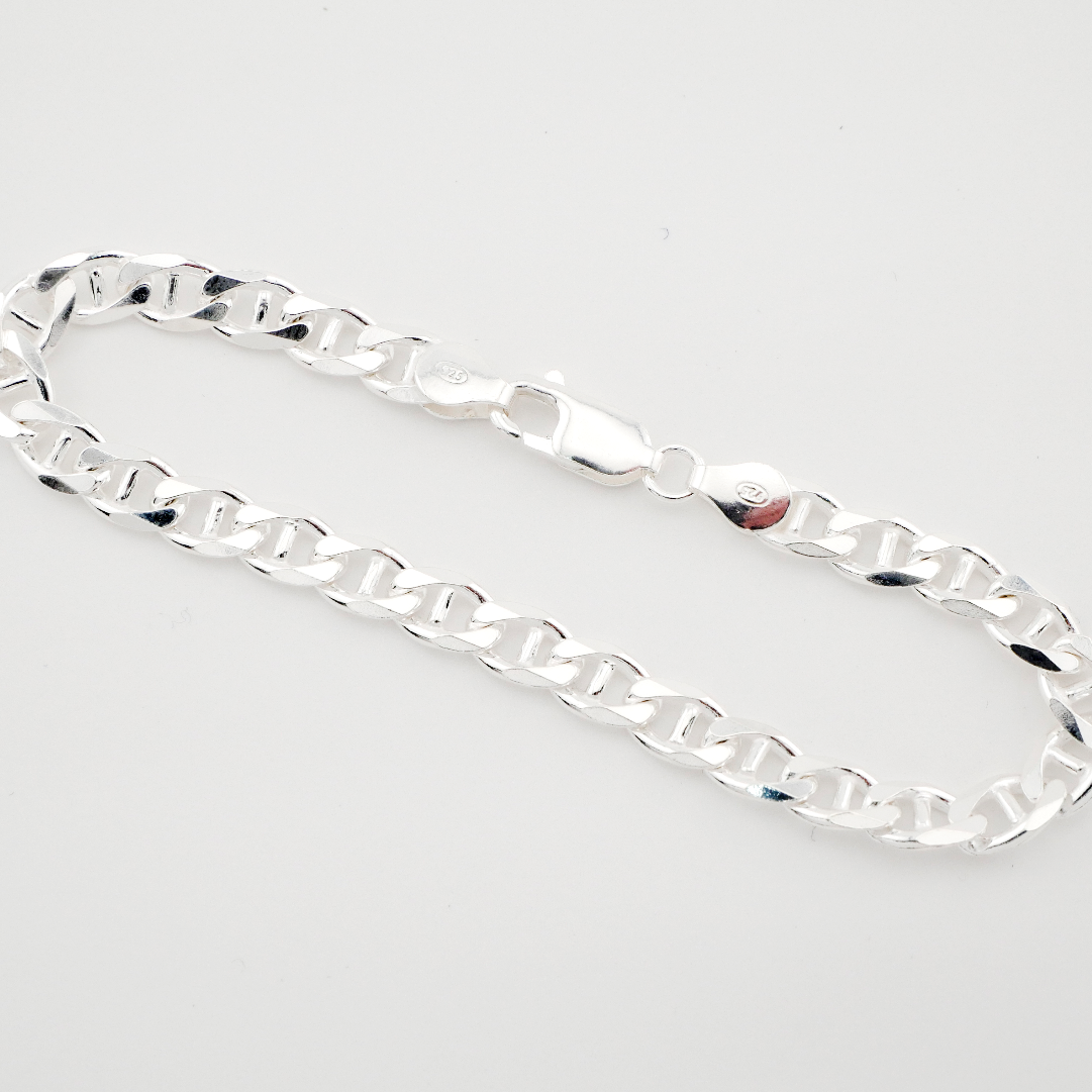 Silver chain bracelet on a light gray background