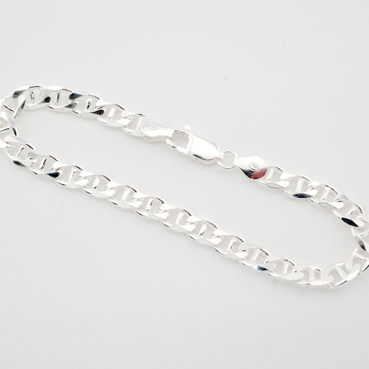 Silver chain bracelet on a light gray background