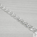 Silver chain bracelet on a light grey background