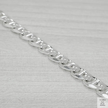 Silver chain bracelet on a light grey background
