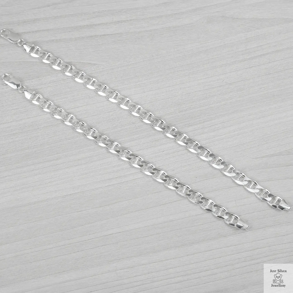 Silver bracelets on a light grey background