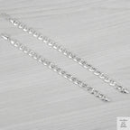 Silver bracelets on a light grey background