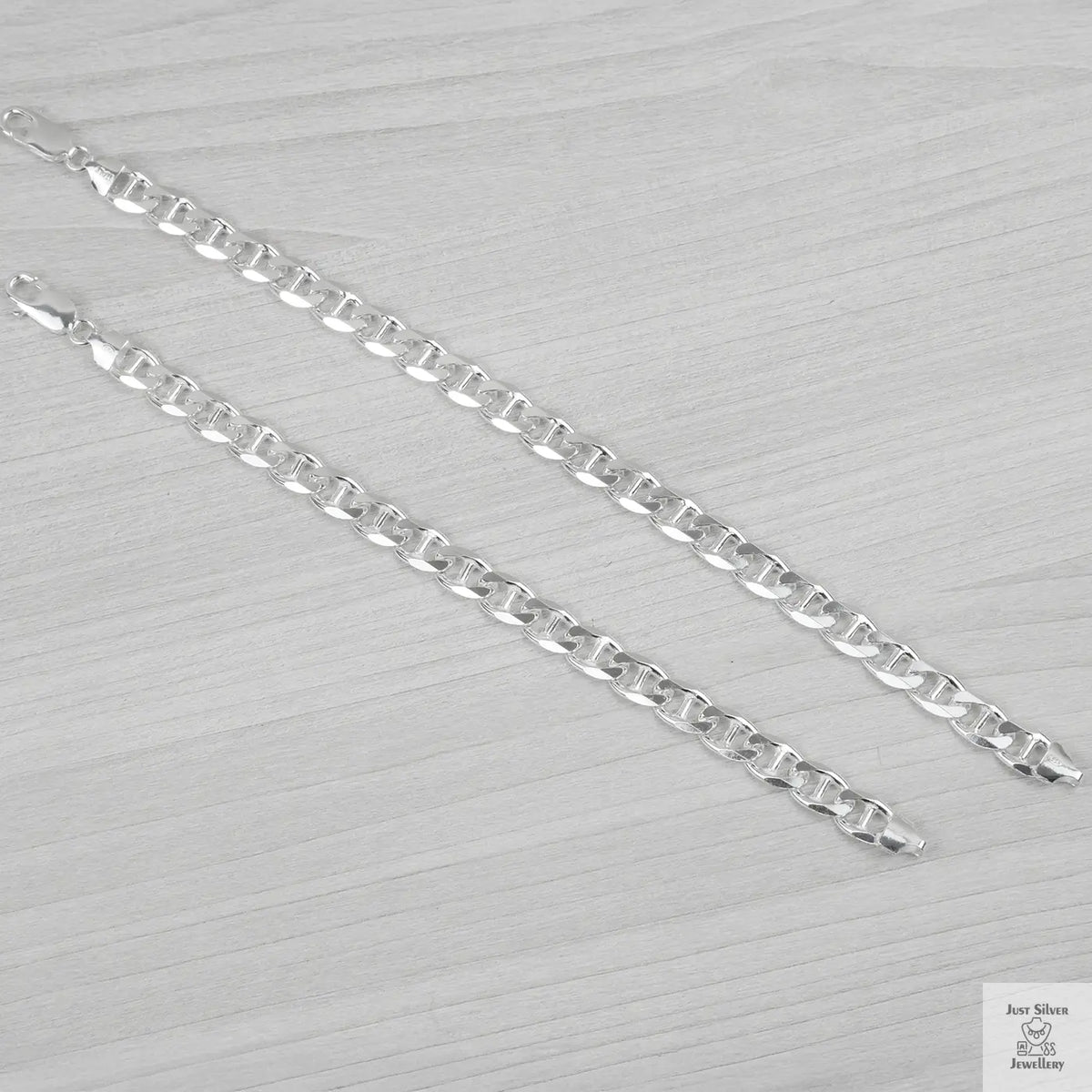 Silver bracelets on a light grey background