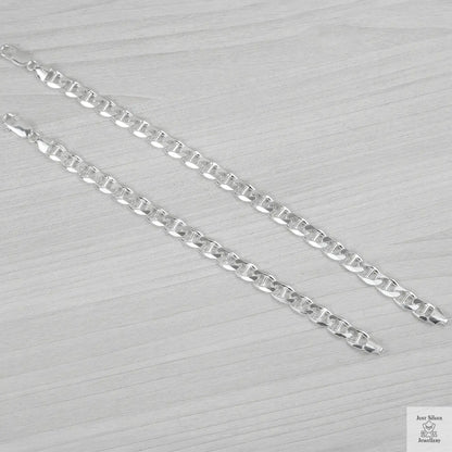 Silver bracelets on a light grey background