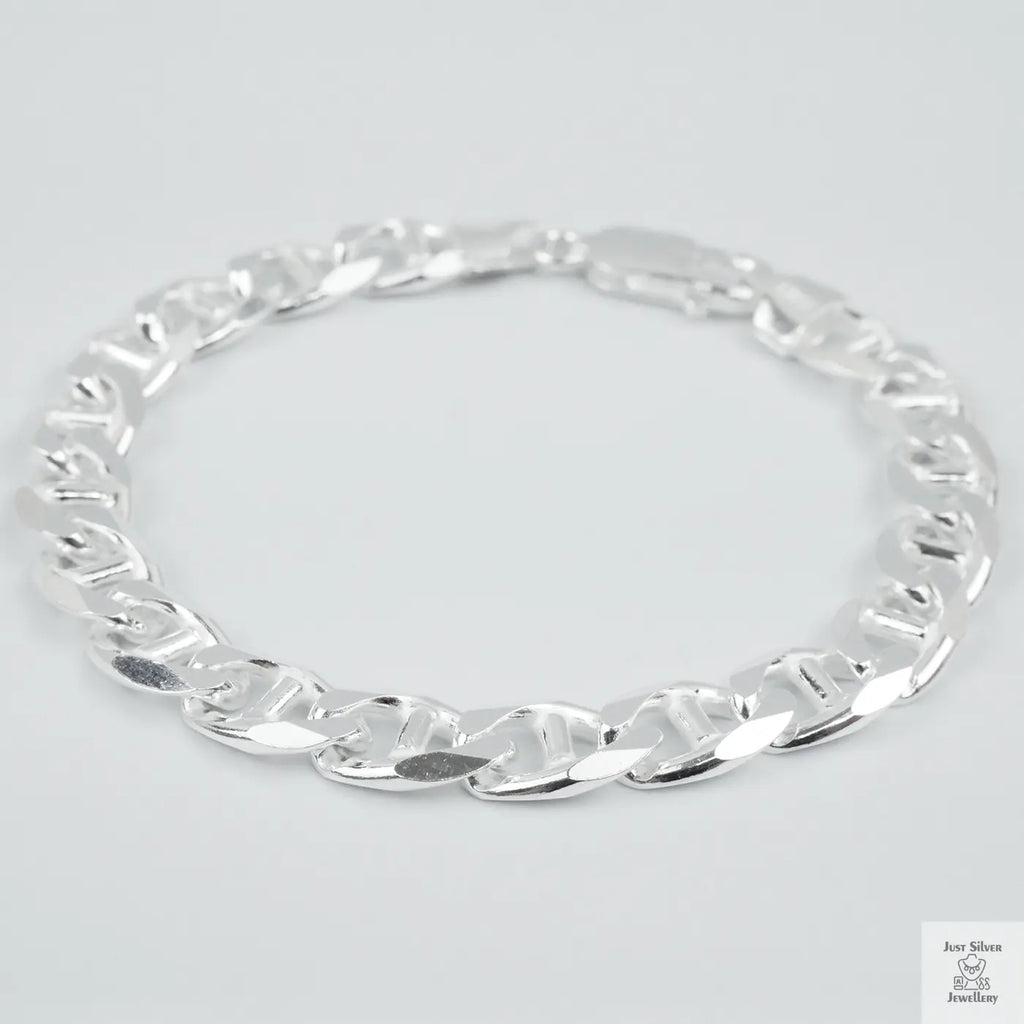 Silver chain bracelet on a light grey background