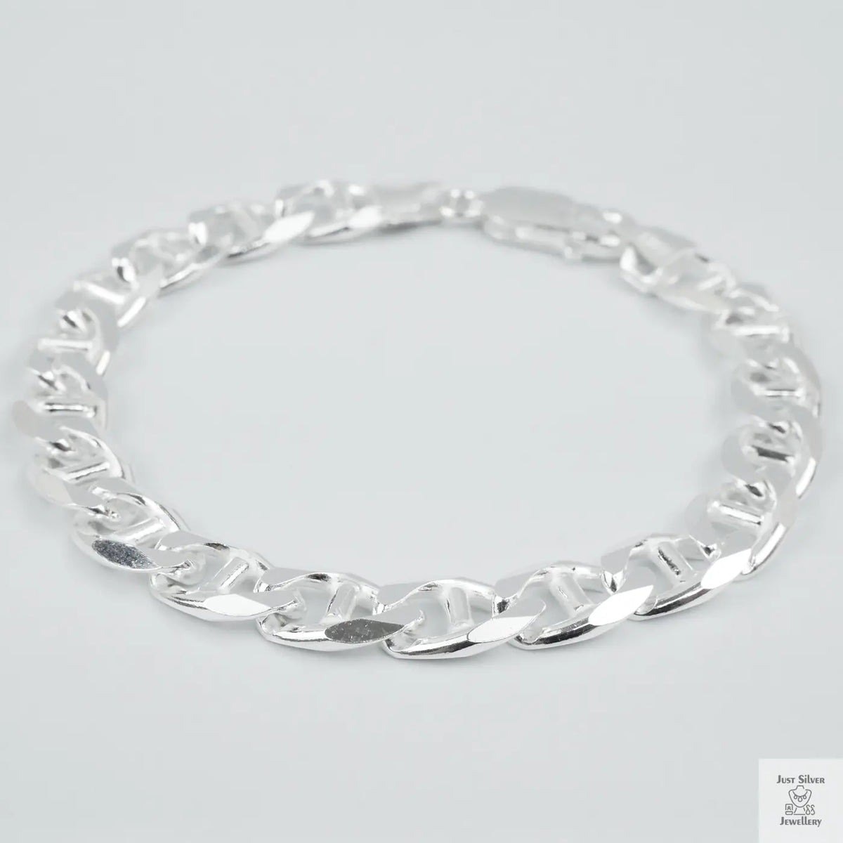 Silver chain bracelet on a light grey background