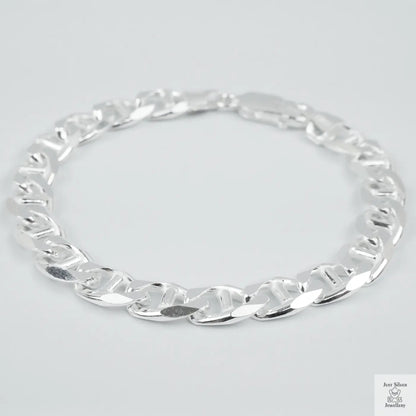 Silver chain bracelet on a light grey background
