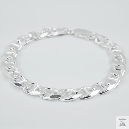 Silver chain bracelet on a light grey background