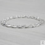 Silver bracelet on a light grey background