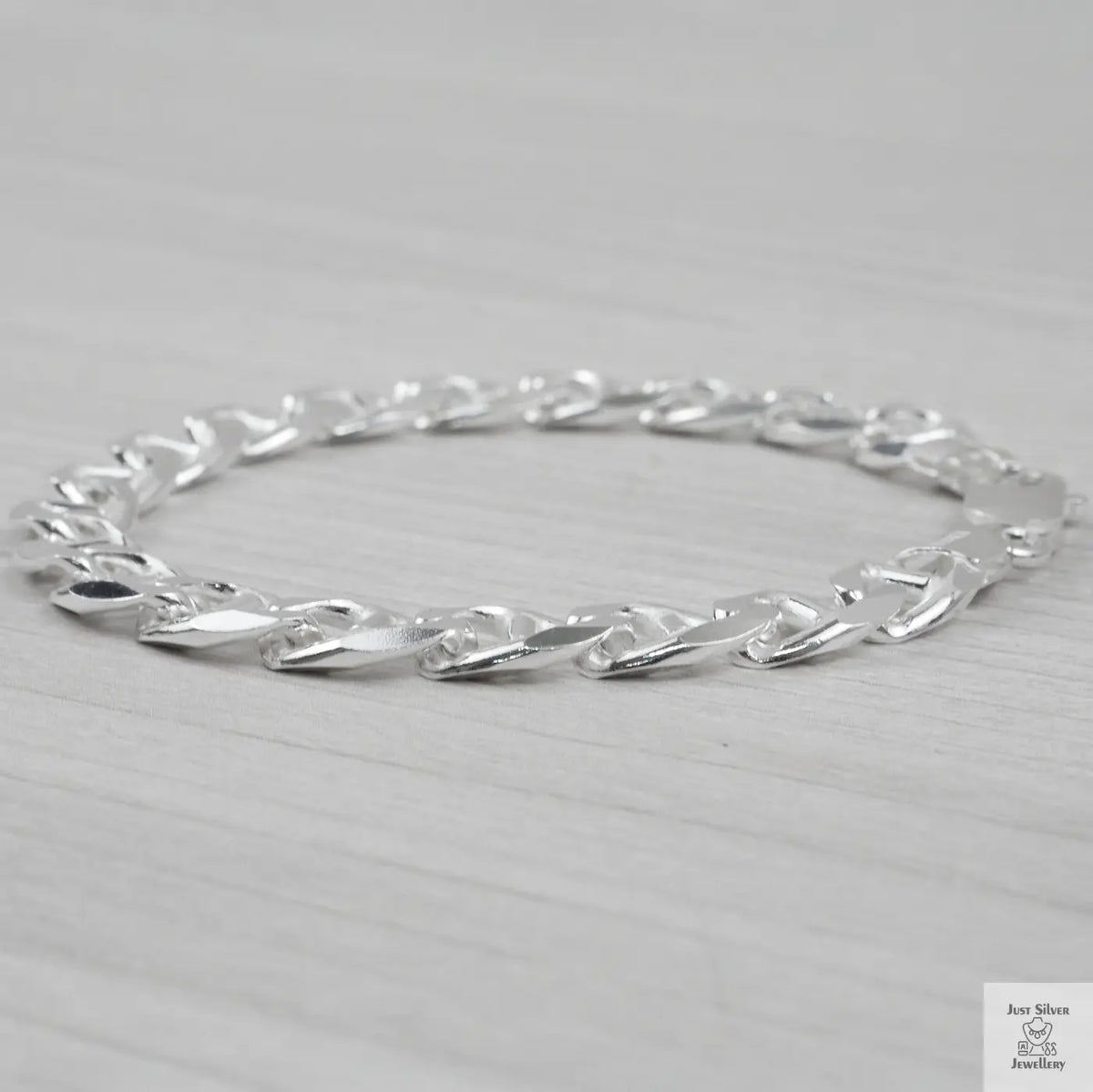 Silver bracelet on a light grey background