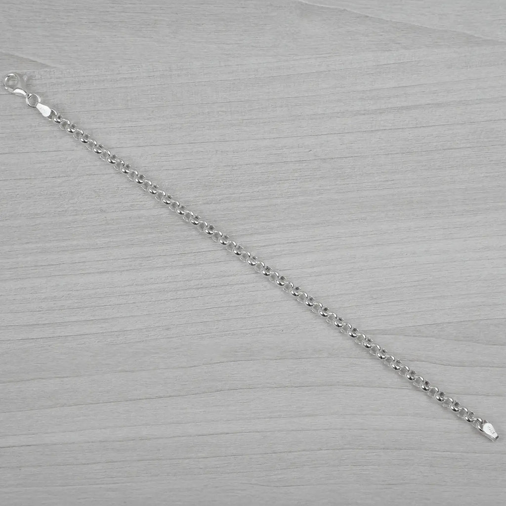 Silver bracelet on a grey textured surface