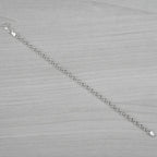 Silver bracelet on a grey textured surface