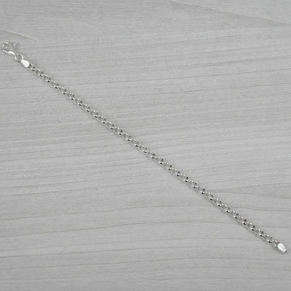 Silver bracelet on a grey textured surface