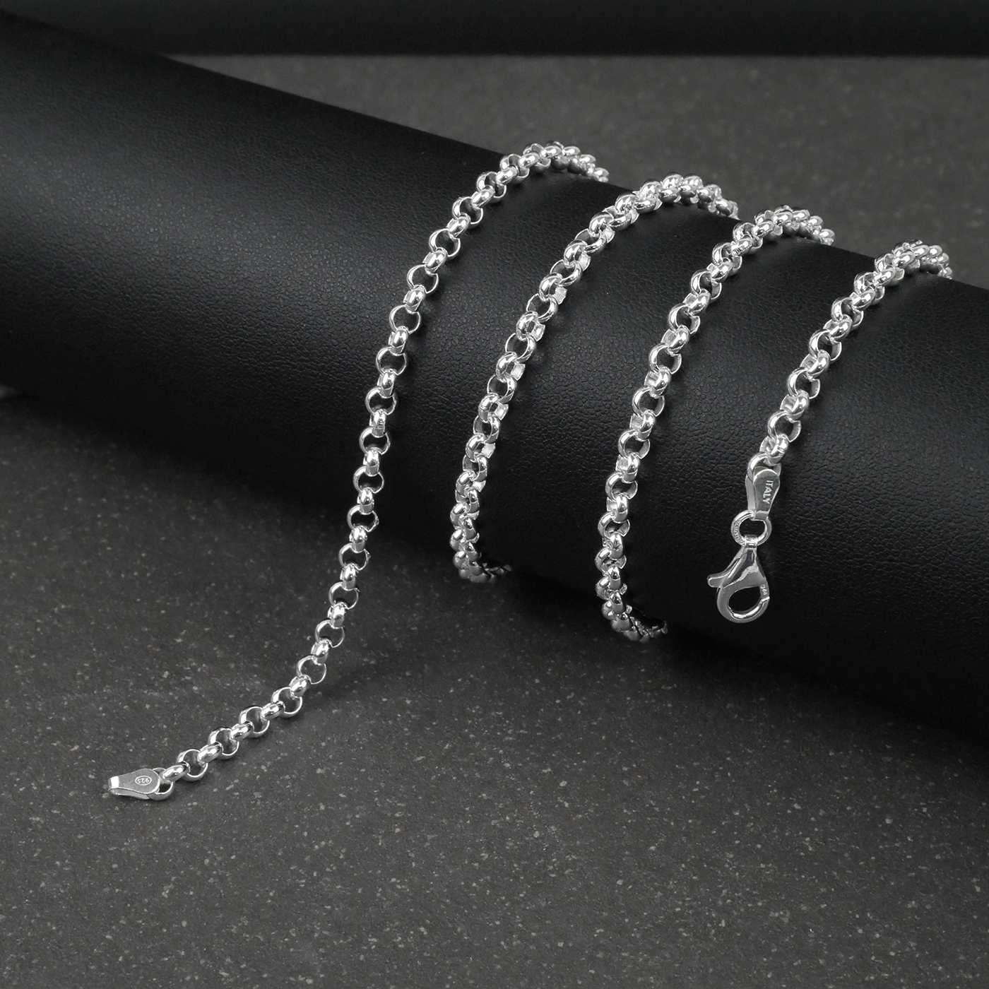 Silver rolo/belcher chain bracelet on a dark surface