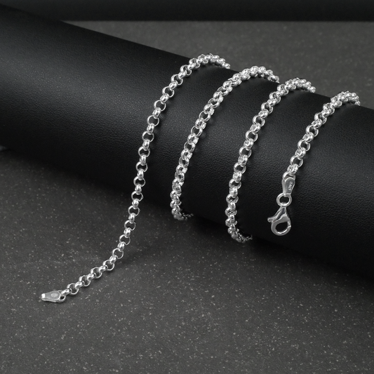 Silver rolo/belcher chain bracelet on a dark surface