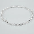 Silver bracelet on a light grey background