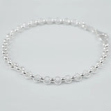 Silver bracelet on a light grey background