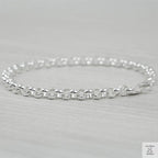 Silver bracelet on a light grey background