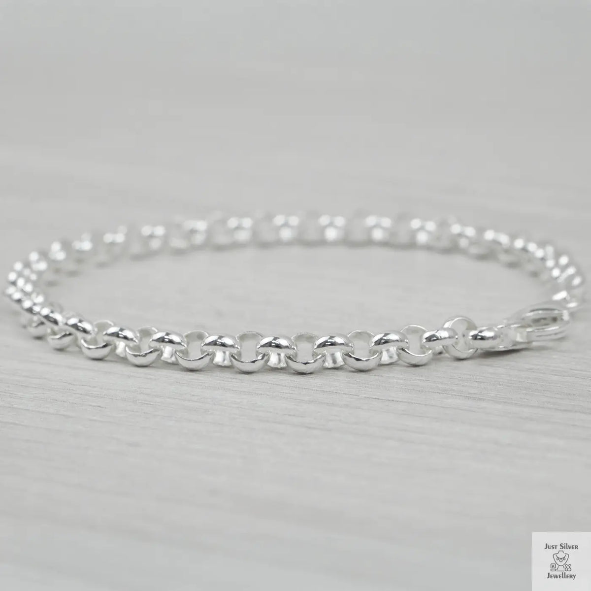 Silver bracelet on a light grey background