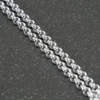 Silver beaded chain on a light gray background
