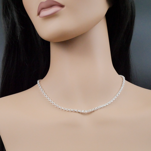 Silver necklace on a mannequin with a plain background