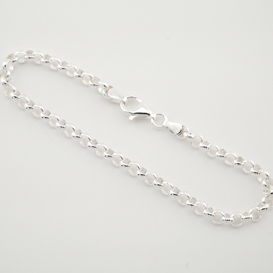Silver chain bracelet on a light gray background