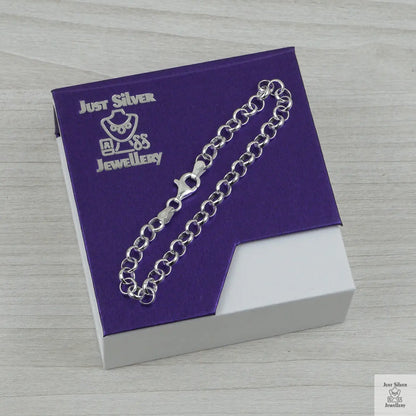Silver bracelet on a purple card with 'Just Silver Jewellery' branding on a wooden surface.