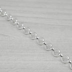 Silver chain on a light grey background