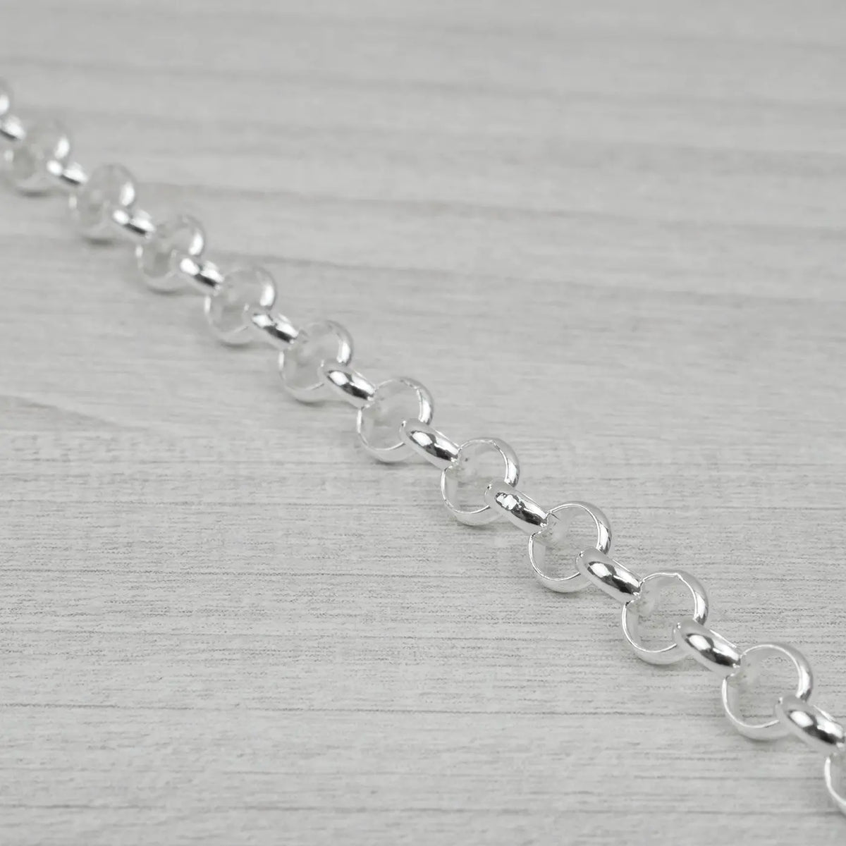 Silver chain on a light grey background